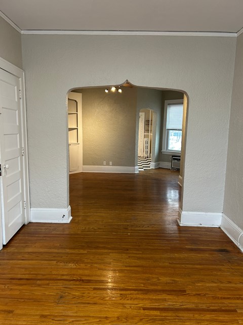 A room with wooden floors and white walls.