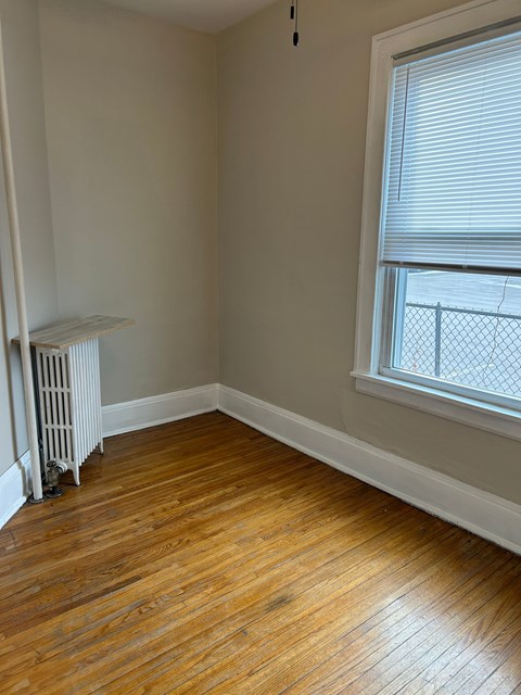 A room with a window and a radiator.