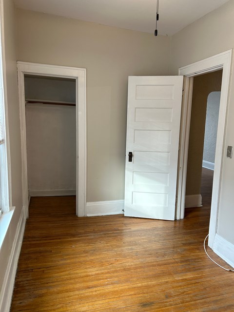 A room with a white door and a window.