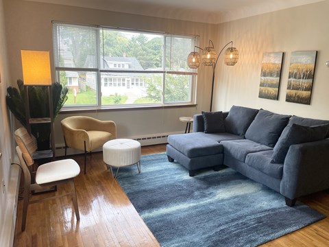 A living room with a grey couch and a yellow chair.