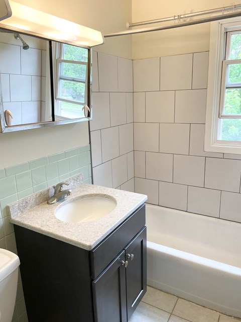 A bathroom with a sink and a window.