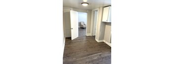 A room with white doors and a grey chair.