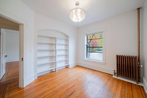 A room with a window and a radiator on the wall.