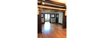 A room with wooden floors and a large window.