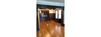 A room with wooden floors and a chandelier.