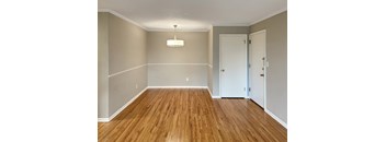 A room with wooden floors and white walls.