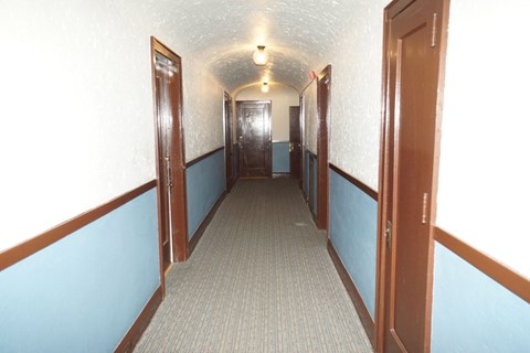 A long hallway with doors on both sides.