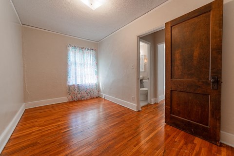 A room with a wooden floor and a door.