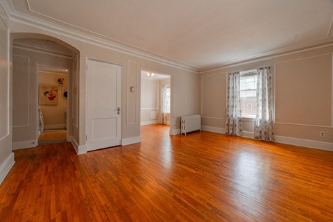 A room with wooden floors and white walls.