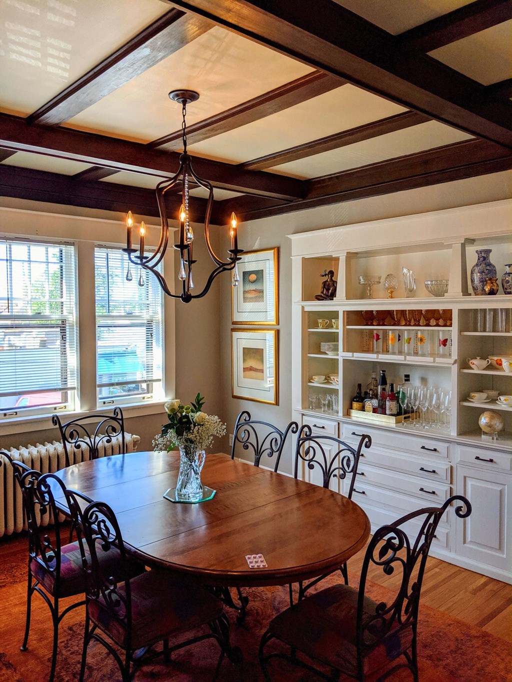 A dining room with a wooden table and chairs.