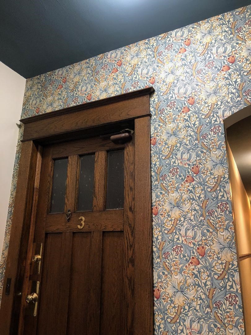 A wooden door with a number 3 on it.