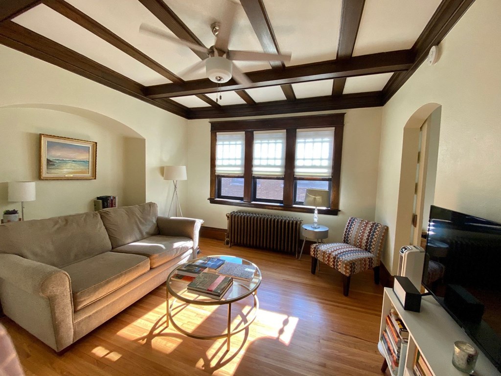 A living room with a couch, chair, and coffee table.