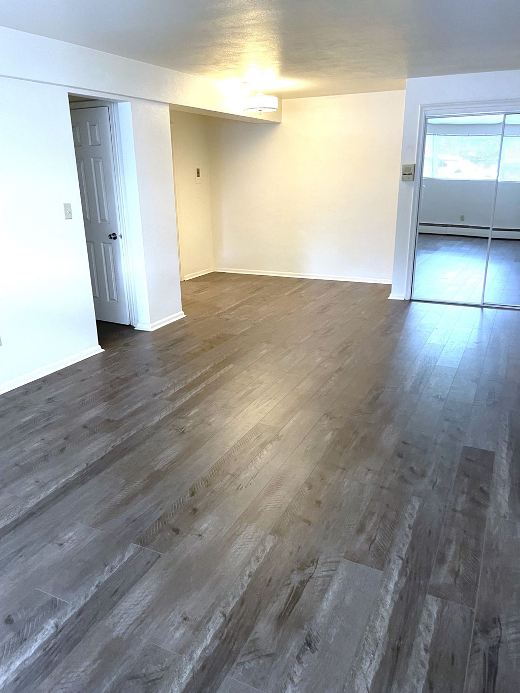 A room with a wooden floor and white walls.
