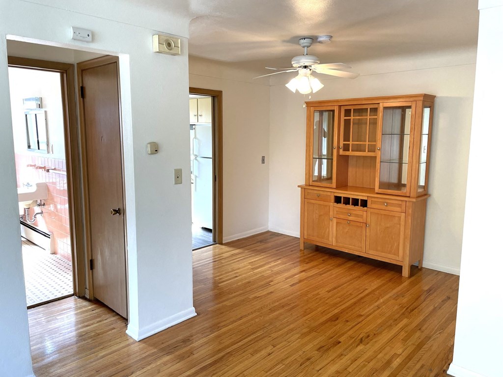 A room with a wooden floor and a wooden cabinet.