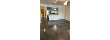 A room with a concrete floor and a ceiling fan.