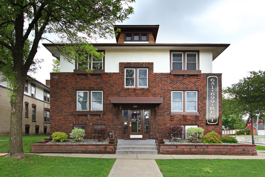 A brick building with a white roof and a sign that says "FISH".