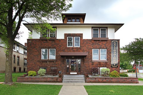 A brick building with a white roof and a sign that says "FISH".