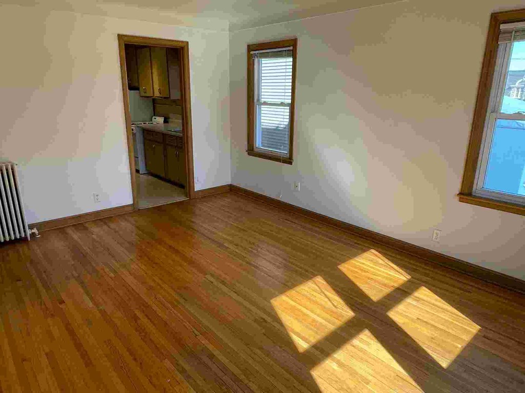 A room with wooden floors and a window.