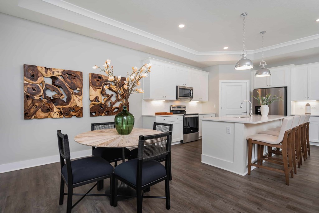 A modern kitchen with a dining table set for four.