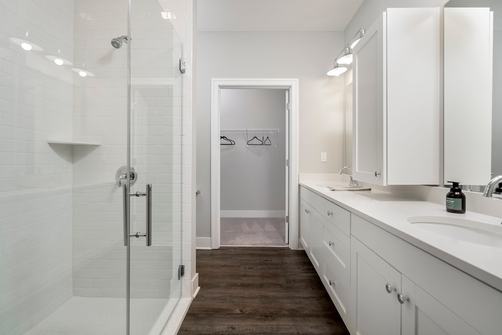 A white bathroom with a walk in shower.