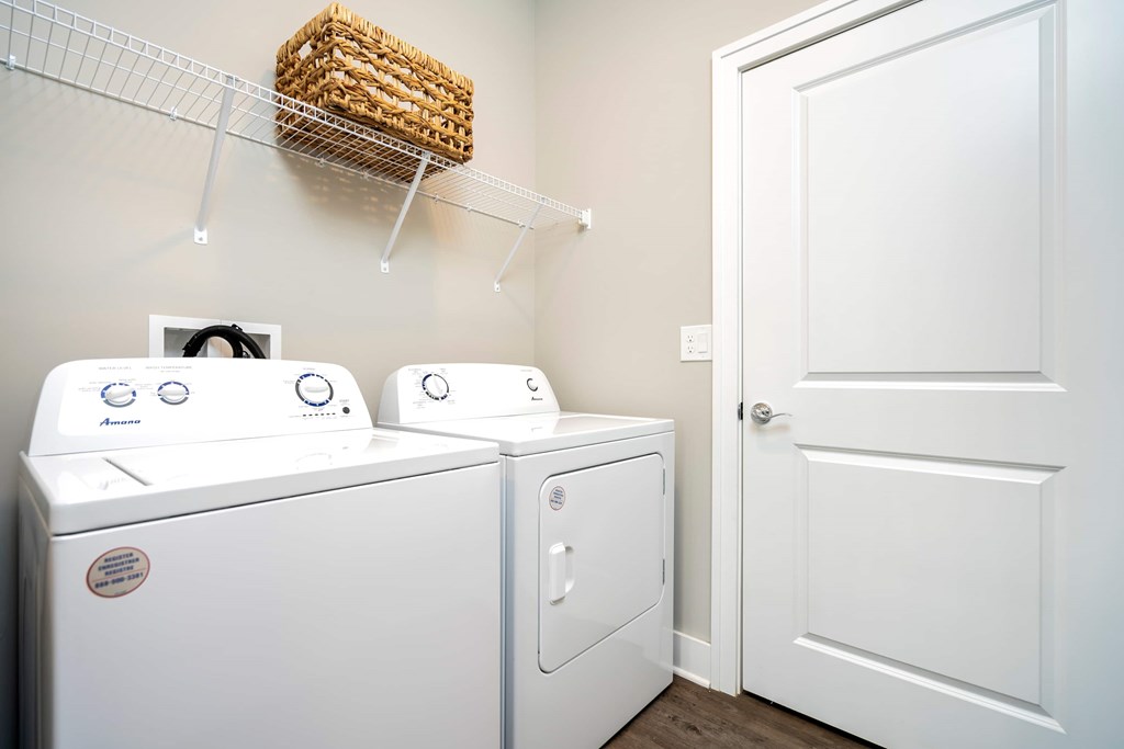 A white washing machine and dryer in a small laundry room.