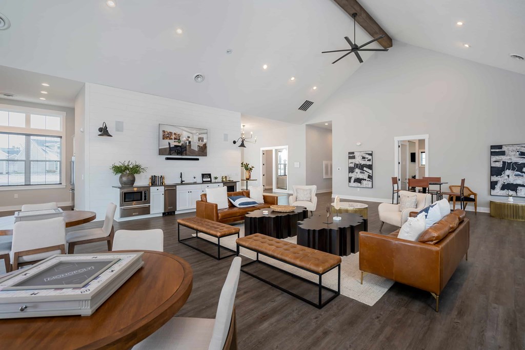 A modern living room with a brown leather couch and a wooden coffee table.