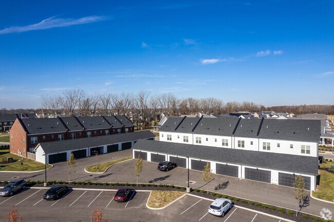 A parking lot with cars and a building in the background.