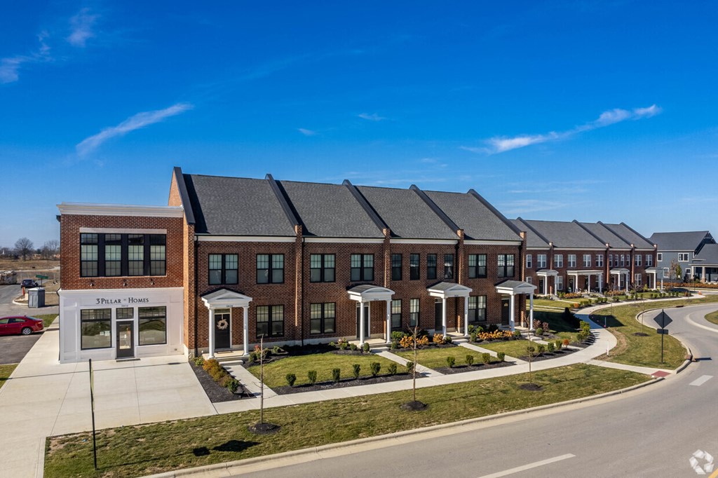 A row of houses with a clear blue sky above them.