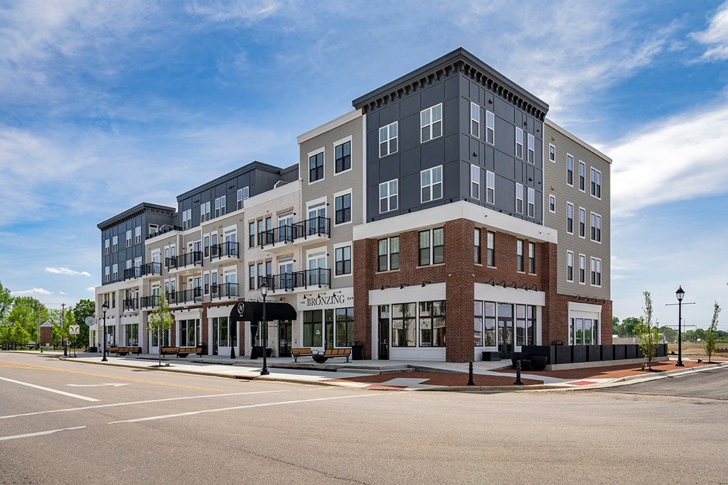 A large building with a parking lot in front of it.