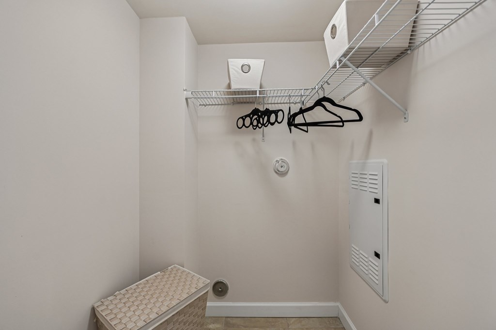 A small closet with a shelf and a bench.