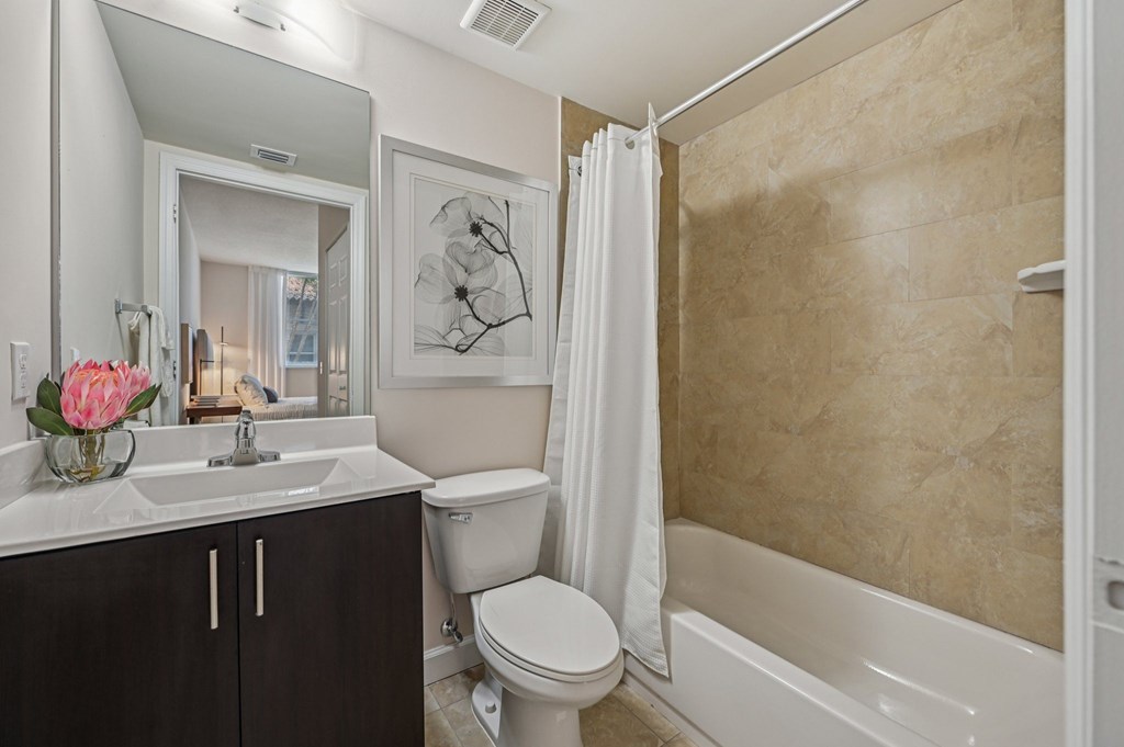A bathroom with a toilet, sink, and bathtub.