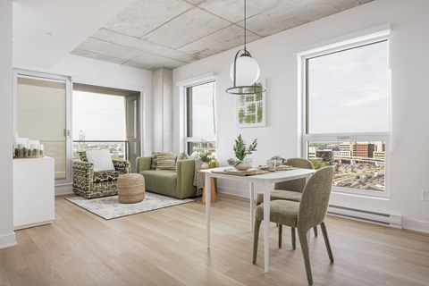 A modern living room with a dining table and chairs.