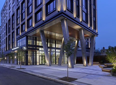 A modern building with a dark facade and large windows.