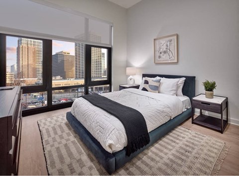 Luxury Bedroom At 55 Union Newark NJ Featuring Floor-To-Ceiling Windows, Skyline Views, Modern Finishes, Spacious Layout In A High-End Apartment Home