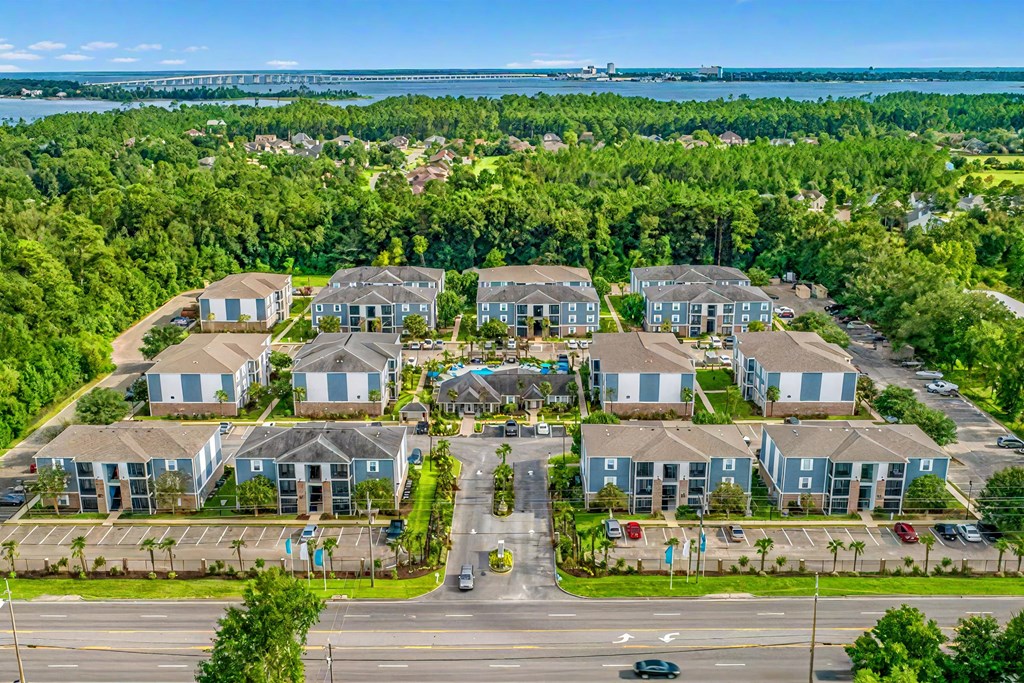 A bird's eye view of a residential area with houses and a road.