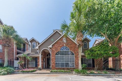 A house with a brick facade and a large arched window.