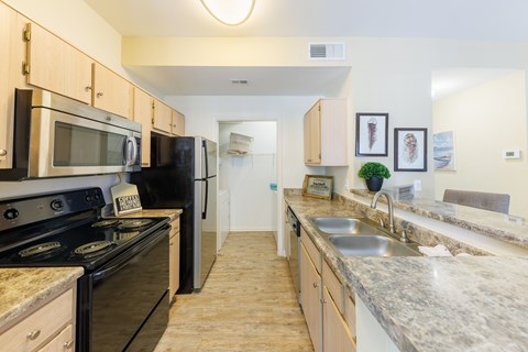 A kitchen with granite countertops and stainless steel appliances.
