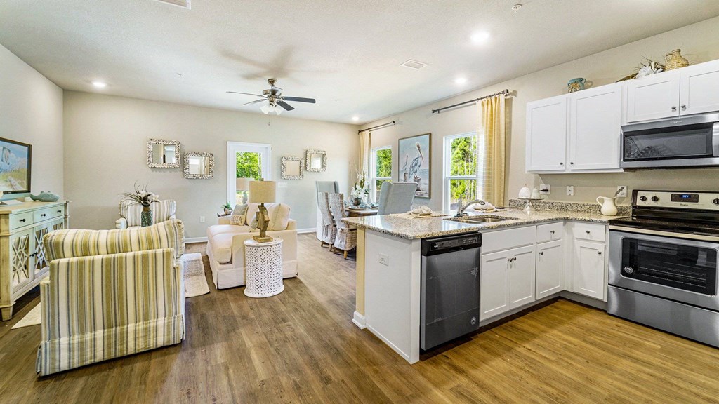 A well-lit kitchen with a striped armchair and a dining table with chairs.