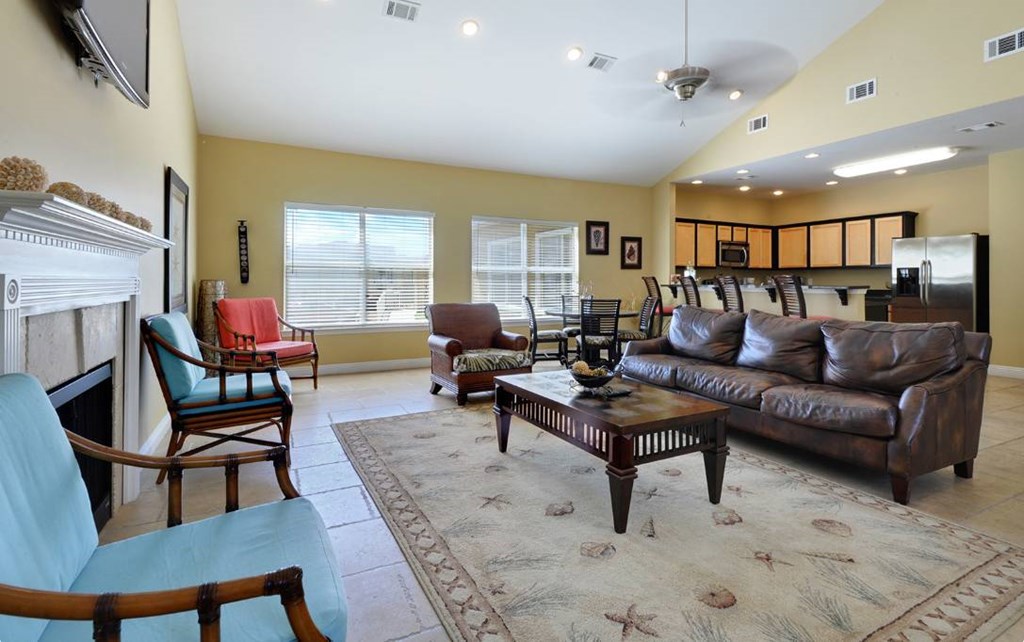 A living room with a fireplace and a blue chair.