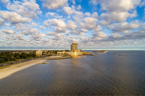 A large body of water with a building in the distance.