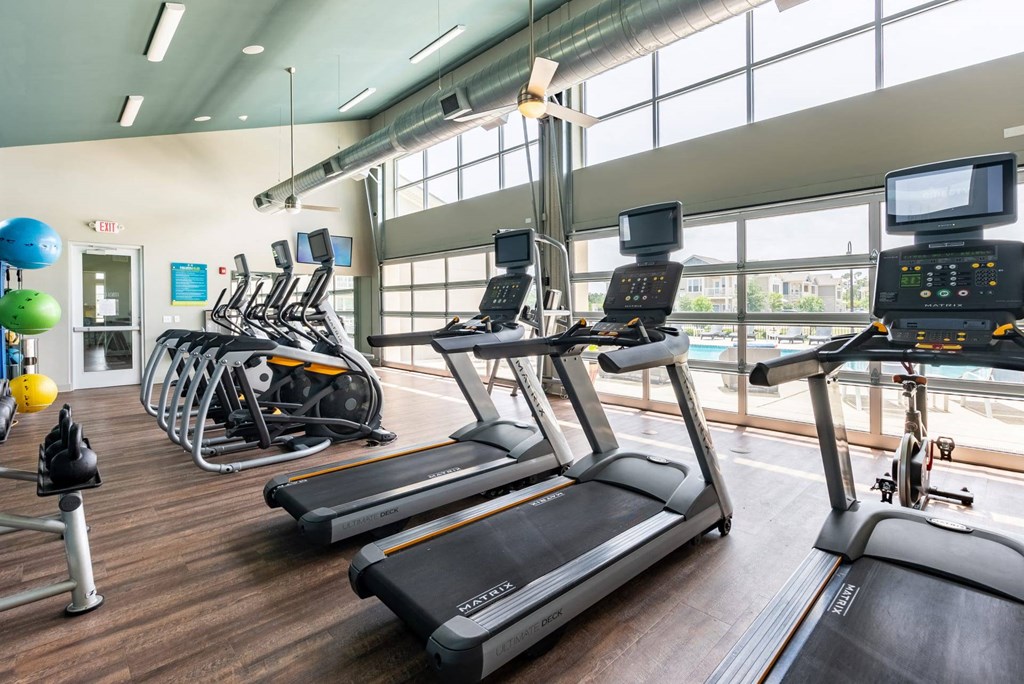 A gym with treadmills and exercise equipment.