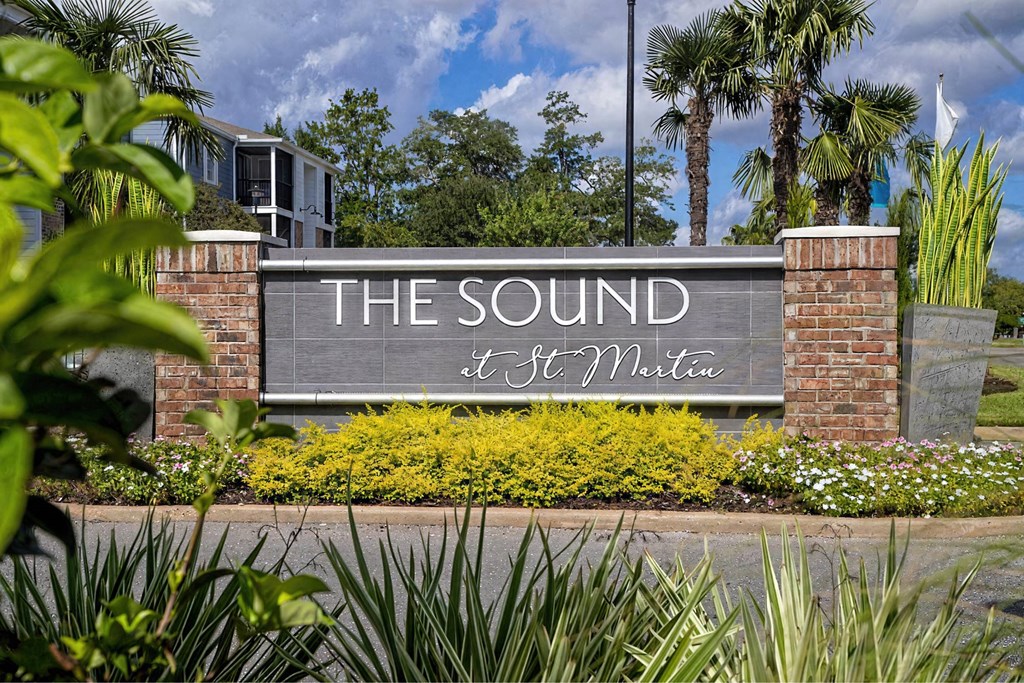 A sign that says "The Sound" is in front of a building.