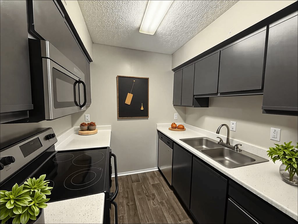 A kitchen with black cabinets and a white countertop.