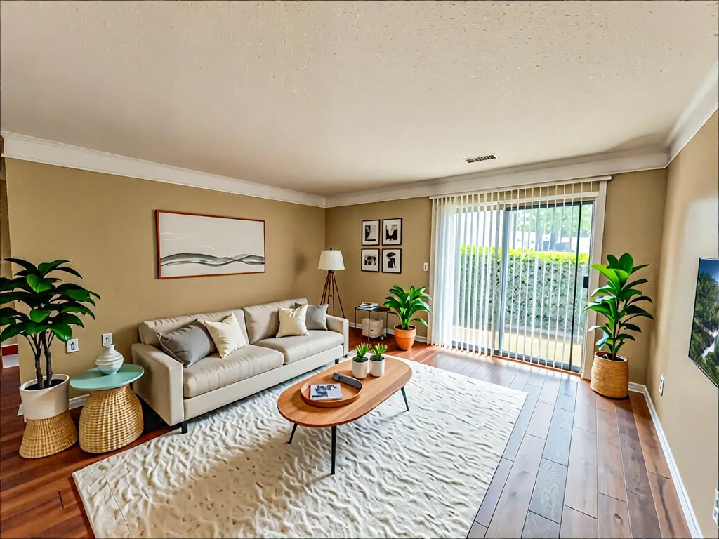 A living room with a couch, a coffee table, and a painting on the wall.