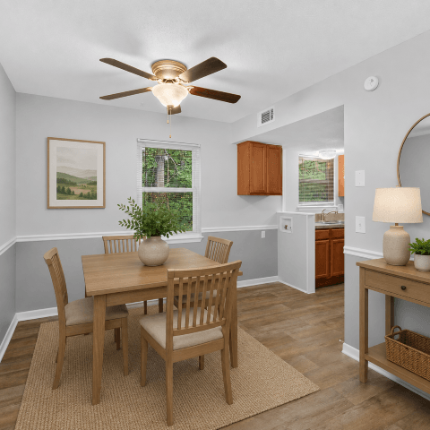 A dining room with a table and chairs.