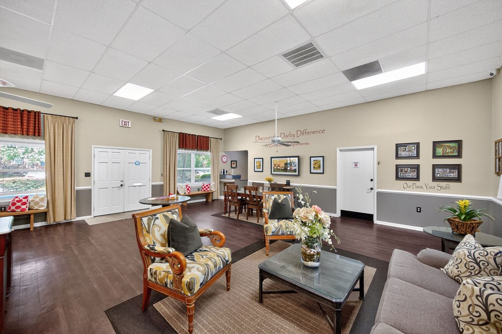 A living room with a couch, chairs, and pictures on the wall at Brackenbrook Apartments, North Charleston, SC
