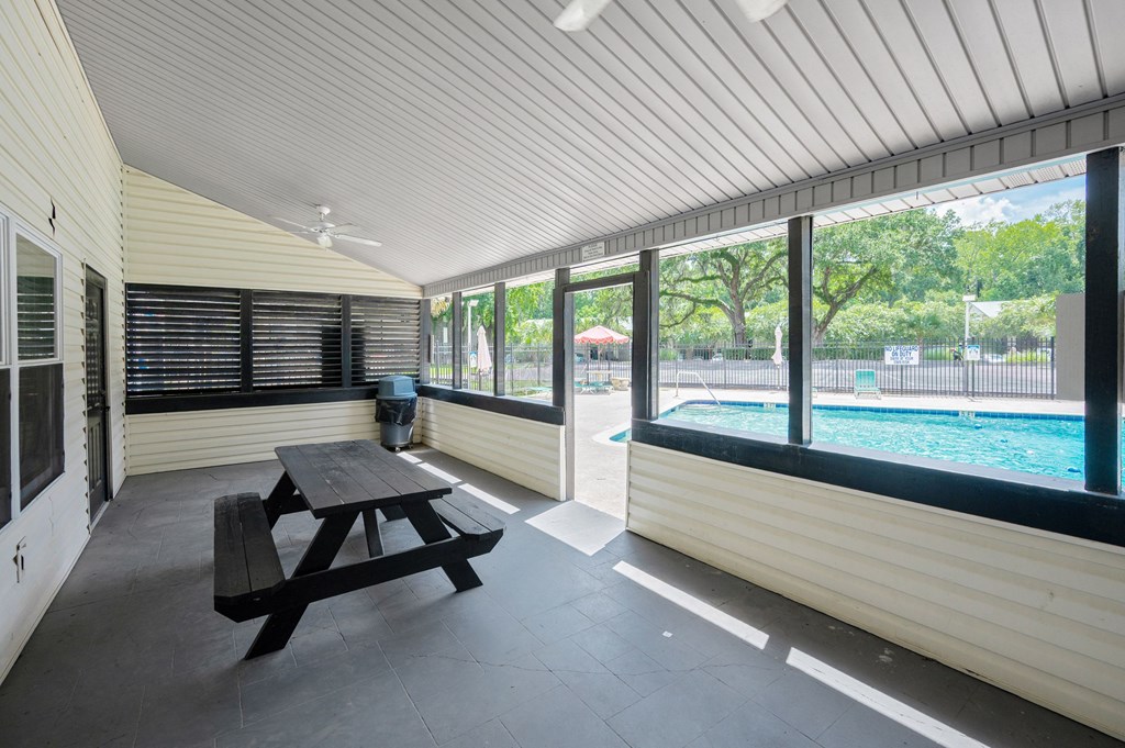 A wooden picnic table is in the middle of a room with a pool table and a window at Brackenbrook Apartments, South Carolina, 29418