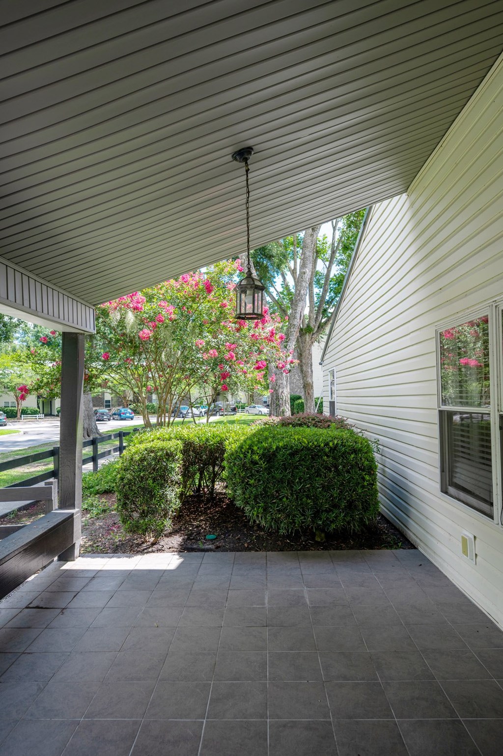 A patio with a bench and a hanging light fixture at Brackenbrook Apartments, South Carolina, 29418