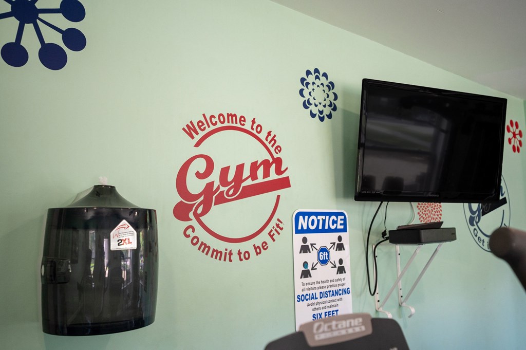 A gym wall with a sign at Brackenbrook Apartments, North Charleston