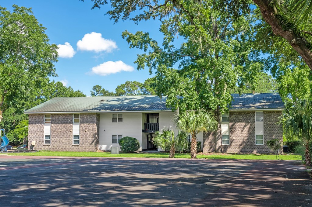 A house with a green roof and a driveway in front at Brackenbrook Apartments, North Charleston, South Carolina